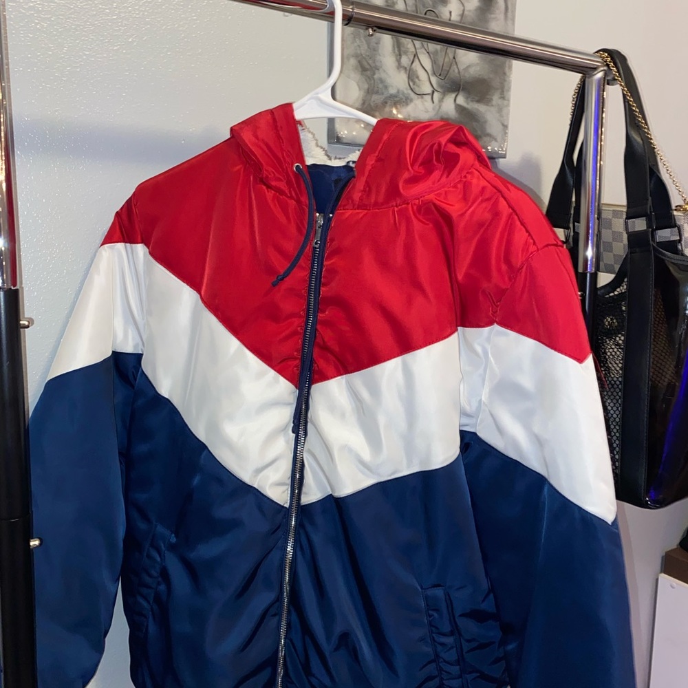 Very cute red and blue zip up jacket with fur in the hood.